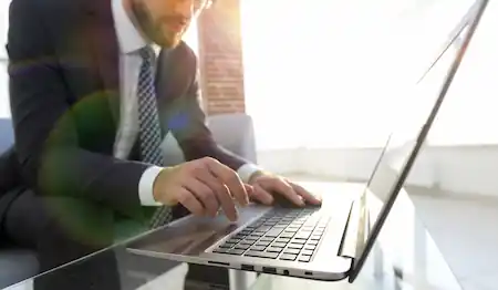 A man installing an application on his laptop