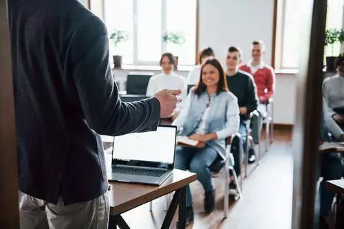 Web developer training clients in a classroom